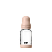 Clear baby bottle with beige cap and 'BIBS' branding on a white background
