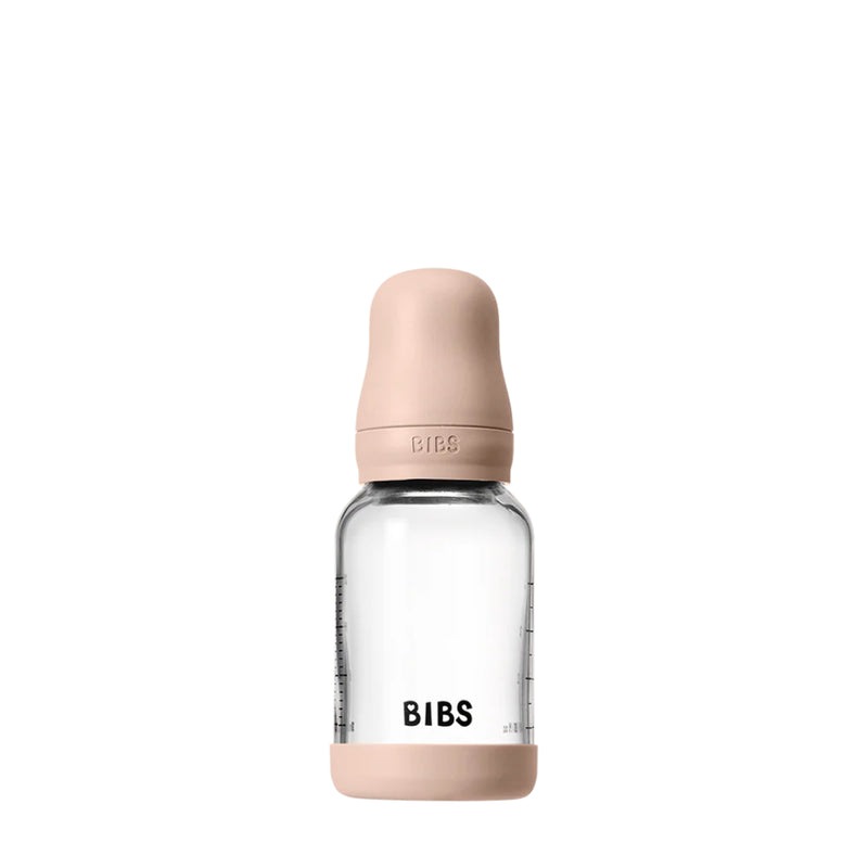 Clear baby bottle with beige cap and 'BIBS' branding on a white background