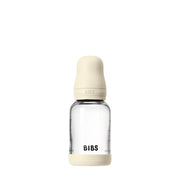 Clear baby bottle with beige cap and 'BIBS' branding on a white background