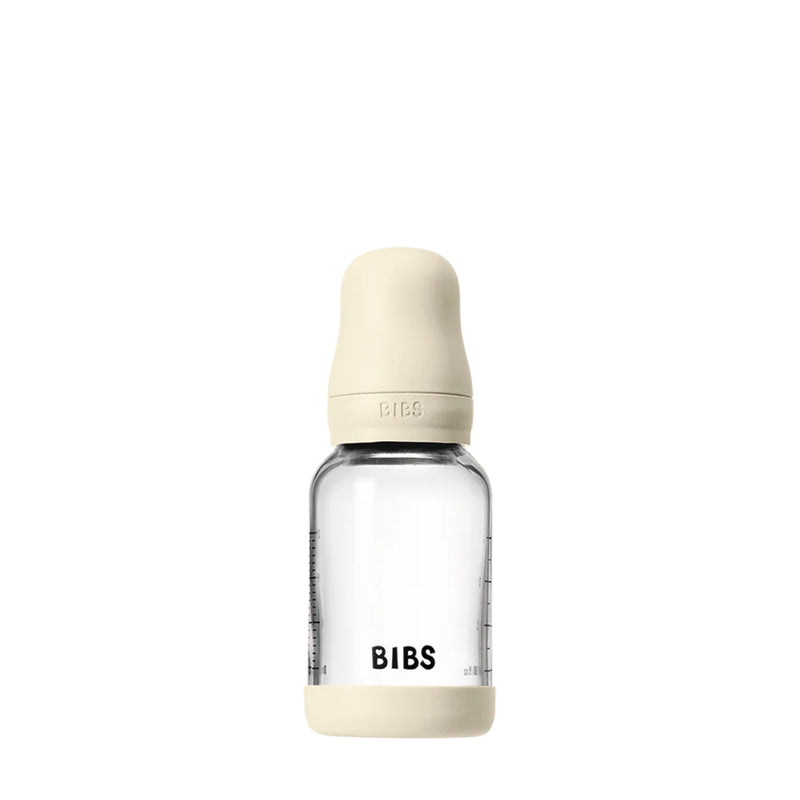 Clear baby bottle with beige cap and 'BIBS' branding on a white background