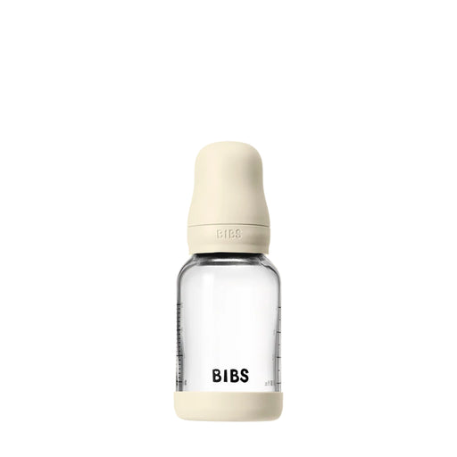 Clear baby bottle with beige cap and 'BIBS' branding on a white background