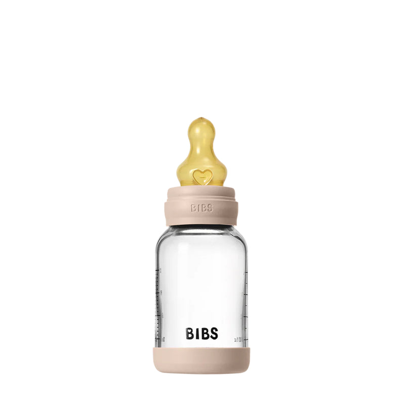 Clear baby bottle with beige cap and 'BIBS' branding on a white background