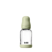 Clear baby bottle with green cap and 'BIBS' branding on a white background