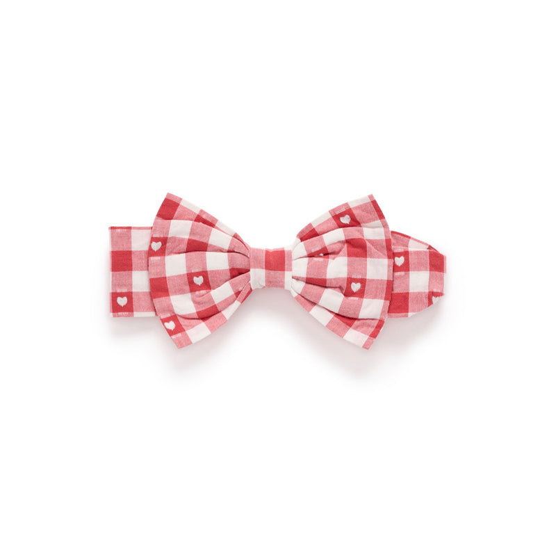 Red and white checkered bow tie on a white background