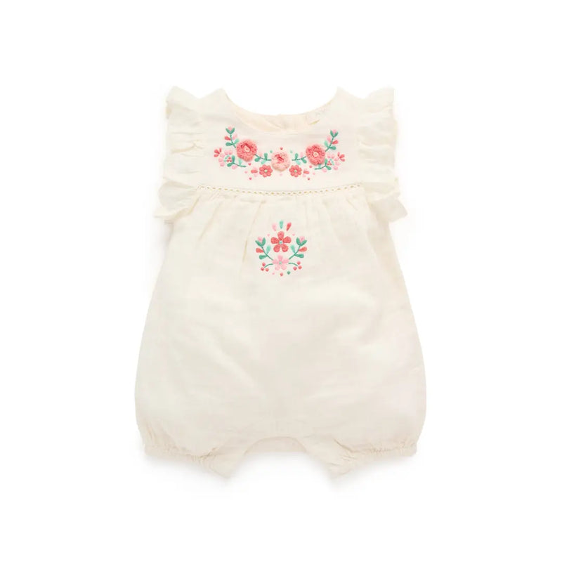 Cream-colored baby romper with floral embroidery on a white background