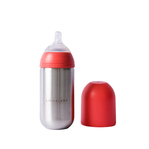 Silver bottle with coral cap and base on a light gray background
