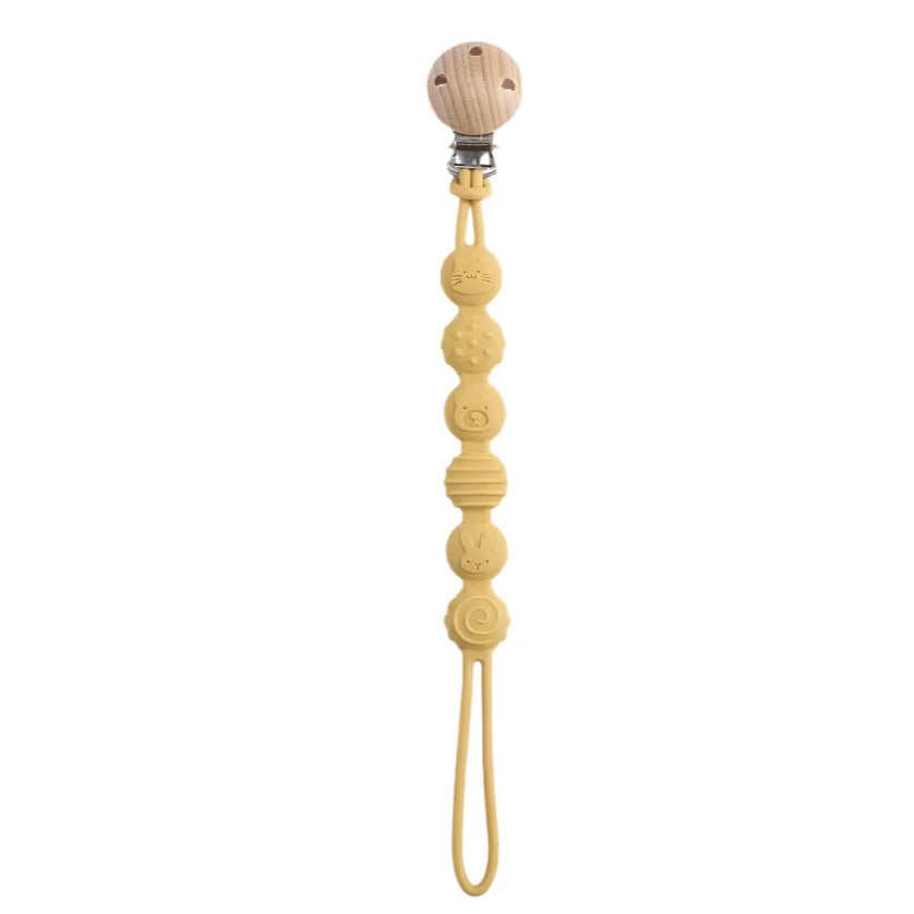 Yellow beaded pacifier clip on a white background